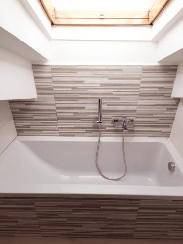 a bathroom with a bath tub with a shower at Cava Resort Costa d'Amalfi in San Pietro