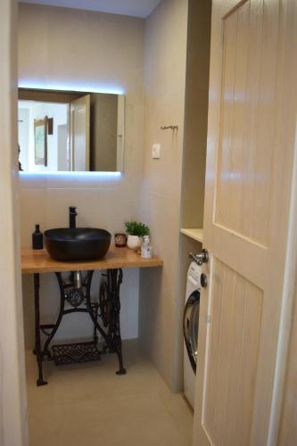 a bathroom with a sink and a mirror at Amazing STUDIO CASA FERMEGLIA with private jacuzzie and perfect panoramic view in Roč