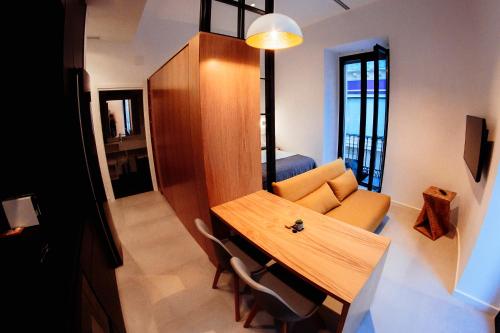 a living room with a table and a couch at Apartamentos Plaza de España 6 in Villanueva de la Serena