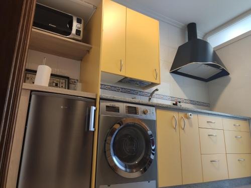 a kitchen with a washing machine and a stove at Harritarte in Getaria