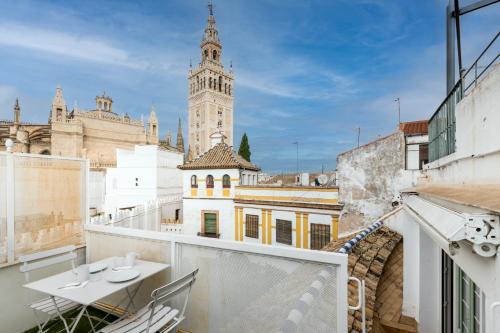 a view from the balcony of a building with a clock tower at Historic Building Cathedral in Seville
