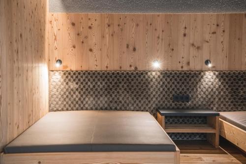 a room with wood paneled walls and a table at Residence Altea in Ortisei