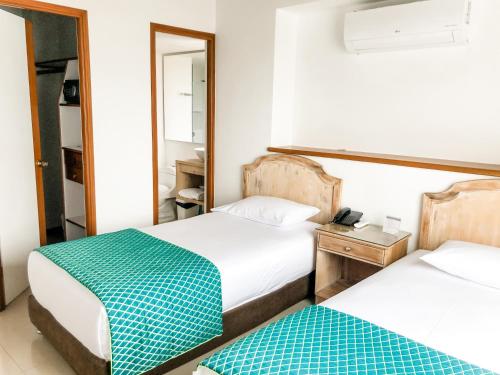 Ένα ή περισσότερα κρεβάτια σε δωμάτιο στο Portal del Rodeo ApartaHotel