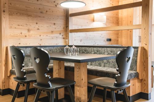 a dining room with a table and two chairs at Residence Altea in Ortisei