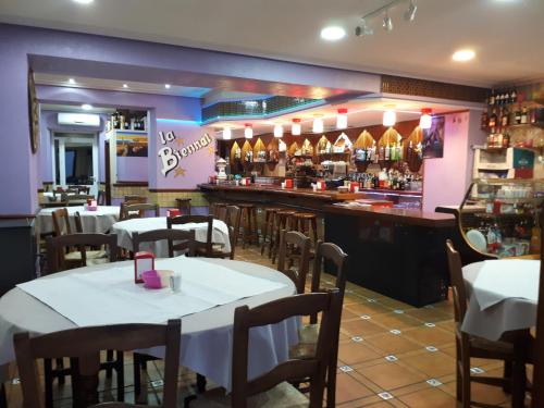 a restaurant with tables and chairs and a bar at APAR. SIERRAGUADALQUIVIR in Quesada