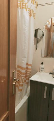 a bathroom with a sink and a shower curtain at Alborada in Pinos Genil