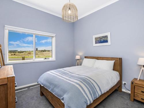 a bedroom with a bed and a window at Saltys in Port Fairy