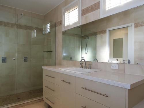 a bathroom with a sink and a shower and a mirror at Aqua Luna in Port Fairy