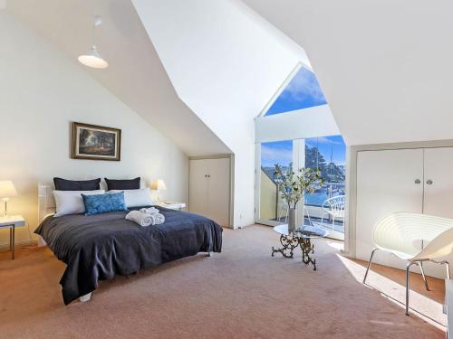 a bedroom with a bed and a large window at Johanssons Perch 2 in Port Fairy