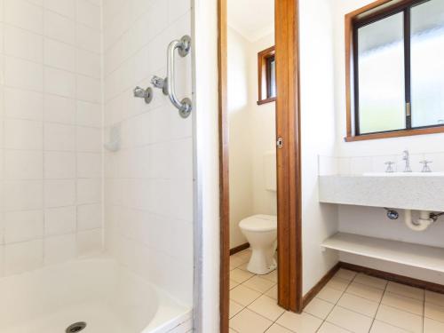 a bathroom with a tub and a sink and a toilet at Eastern Beach Unit 5 in Port Fairy