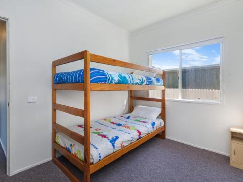 a bedroom with two bunk beds and a window at Julieanne in Port Fairy