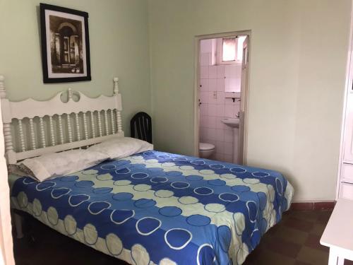 a bedroom with a bed and a bathroom at Casa Acogedora Tarija in Tarija