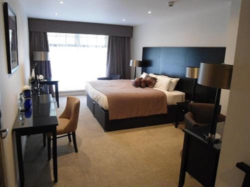 a hotel room with a bed and a desk at Links Hotel in Montrose