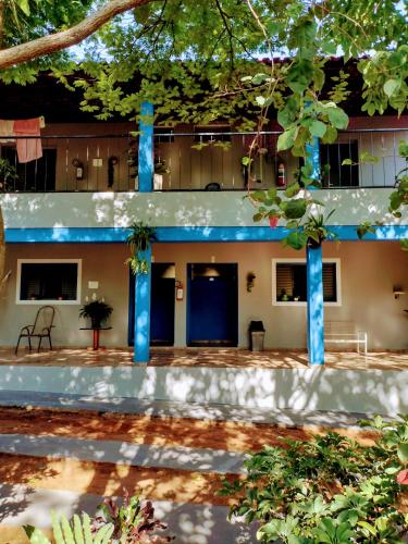 a building with blue columns in front of it at Suits - Canto do sabia in Brotas