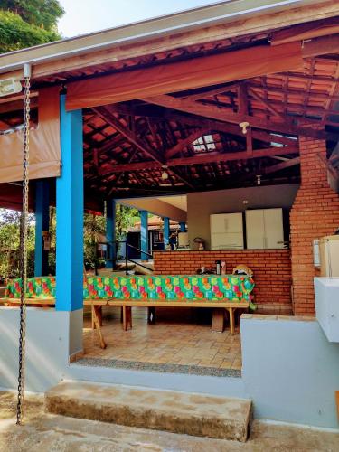 a pavilion with a bench on a patio at Suits - Canto do sabia in Brotas