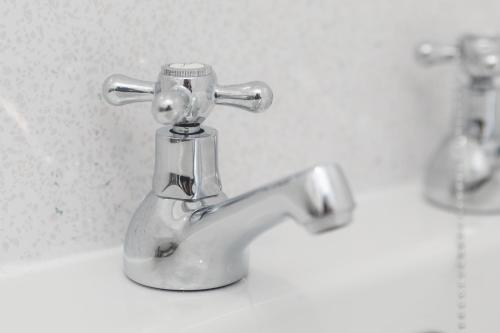 a bathroom sink with a silver faucet at Luke Stays - Finsbury Street in Monkwearmouth