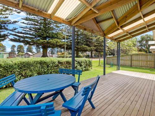 a blue picnic table and chairs on a wooden deck at Yachthouse in Port Fairy