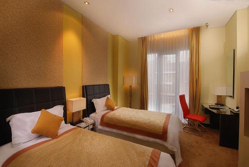 Letto o letti in una camera di Golden Flower by KAGUM Hotels