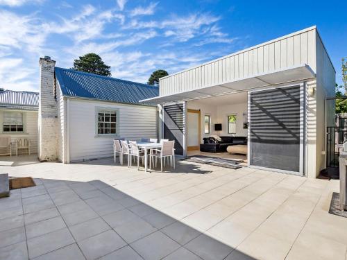 an outdoor patio with a table and chairs at Doran in Port Fairy