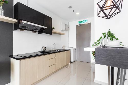 a kitchen with a sink and a counter at Pinnacle PJ @ Penguin Homes in Petaling Jaya