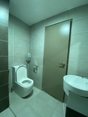a bathroom with a toilet and a sink at Pinnacle PJ @ Penguin Homes in Petaling Jaya