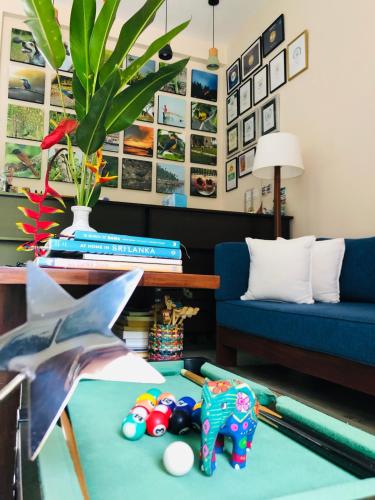 a living room with a blue couch and a table at Peacock Villa in Mirissa