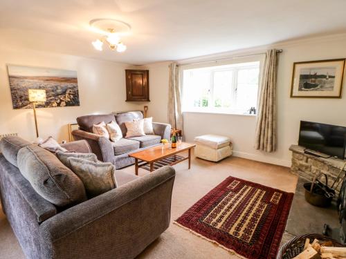 a living room with two couches and a tv at Coverdale Cottage in Carlton
