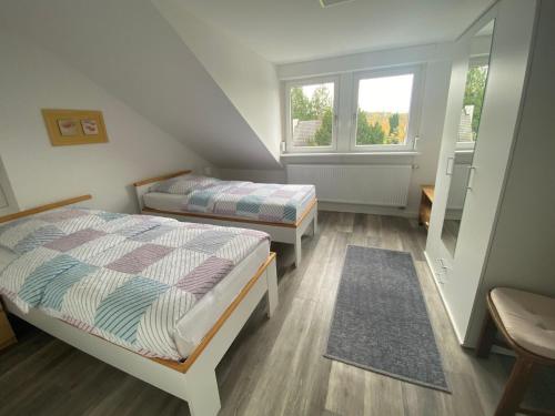 a small bedroom with two beds and a window at Apartment Ehrenbreitstein in Koblenz