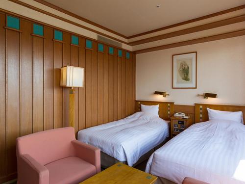 Ένα ή περισσότερα κρεβάτια σε δωμάτιο στο Hokkaido Hotel