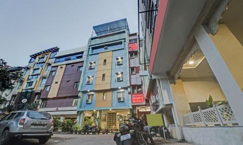 a row of buildings on a city street with cars at Treebo Trend Mohit Regency in Bhopal