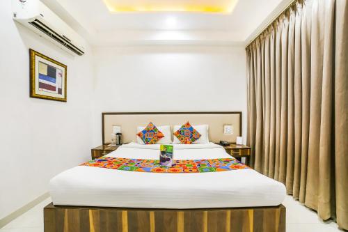 a bedroom with a large bed in a room at FabHotel Prime Sapphire Inn in Jaipur