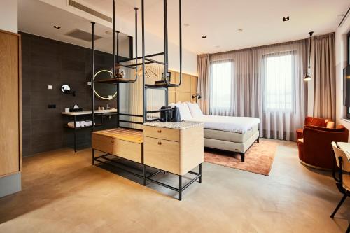 a hotel room with a bed and a couch at Notiz Hotel Leeuwarden in Leeuwarden