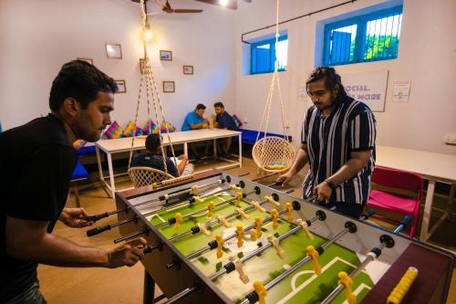 a group of men playing a game of foosball at goSTOPS Lite Alleppey in Alleppey