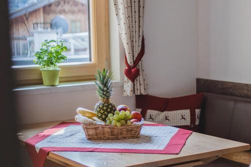 a basket of fruit sitting on top of a table at Apartment Edith in Telfes im Stubai