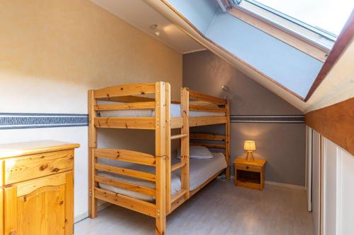 a bedroom with two bunk beds and a desk at La P'tite Maison... in Sickert
