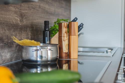 a counter with a knife block and a bottle of wine at Apartment Edith in Telfes im Stubai