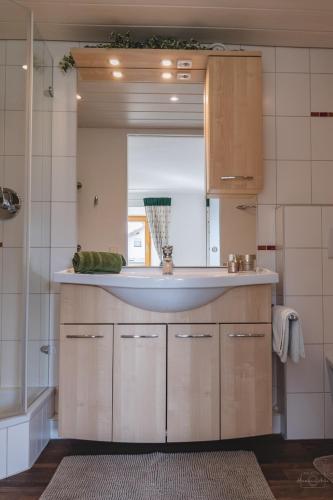 a kitchen with a sink and a mirror at Apartment Edith in Telfes im Stubai