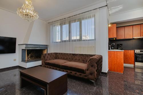 a living room with a couch and a table at Filippos Acharnes Elegance in Akharnaí