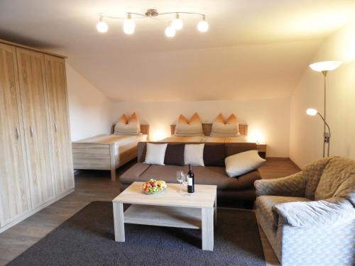 a living room with a bed and a couch at Appartements Hirsch in Bad Birnbach