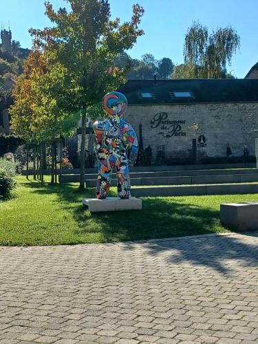 a statue of a person in a park at Le poirier de Warre in Durbuy