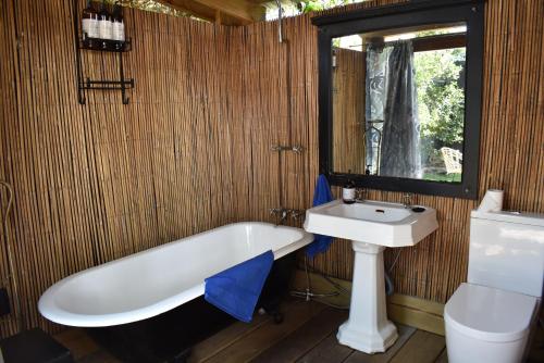 a bathroom with a bath tub and a sink at Discover Bali in Booker Bay in Booker Bay