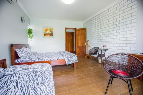 a room with two beds and a table and chairs at Airi Villas Ba Vì Venue Travel in Ba Vì