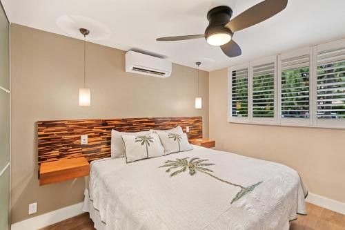 a bedroom with a bed and a ceiling fan at Kanai A Nalu Resort 114 in Wailuku
