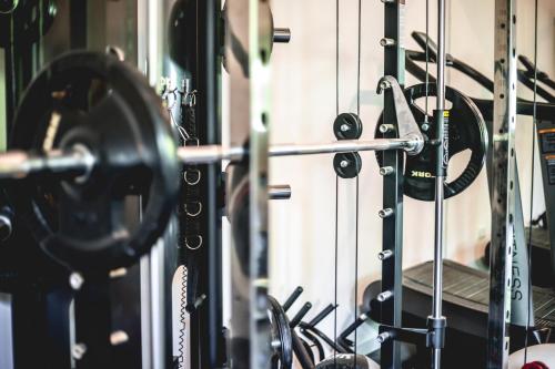 a gym with a lot of equipment in it at Lear Sense Hotel in Gedera