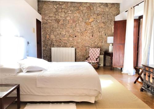 
a hotel room with a bed and a television at Mirabó de Valldemossa in Valldemossa
