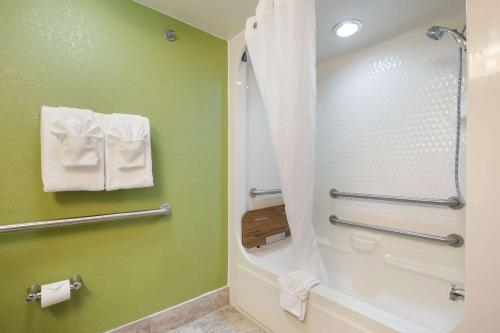 a bathroom with a shower and a toilet at Sleep Inn & Suites in Grand Rapids