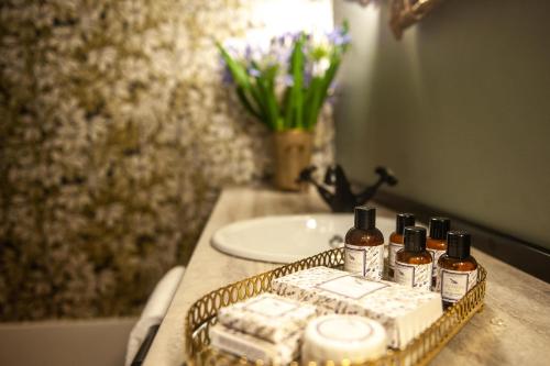 a bathroom counter with a tray of soap and a sink at Conquistador Palace in Guimarães