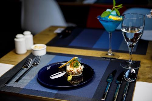 a plate of food on a table with a glass at Ibis Istanbul Tuzla Hotel in Tuzla