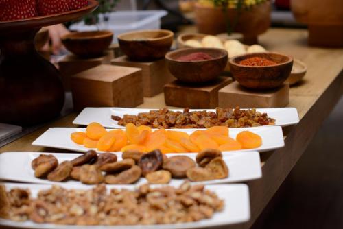 a table with different types of food on plates at Ibis Istanbul Tuzla Hotel in Tuzla