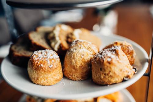 a plate of donuts with powdered sugar on it at Killaloe Hotel & Spa in Killaloe